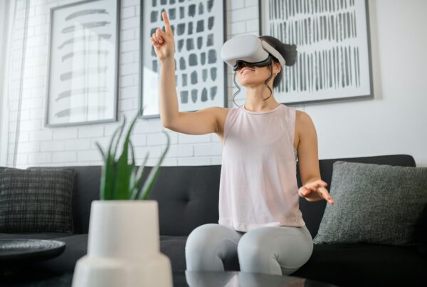 Virtual reality, metaverse and gaming with a woman in the living room of her home using a headset t